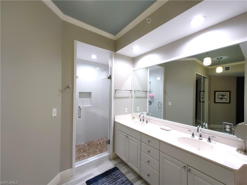 400 Flagship Drive, Unit 501 Naples, FL 34108 - Photo 20 of 38 a bathroom with a double vanity sink mirror and shower