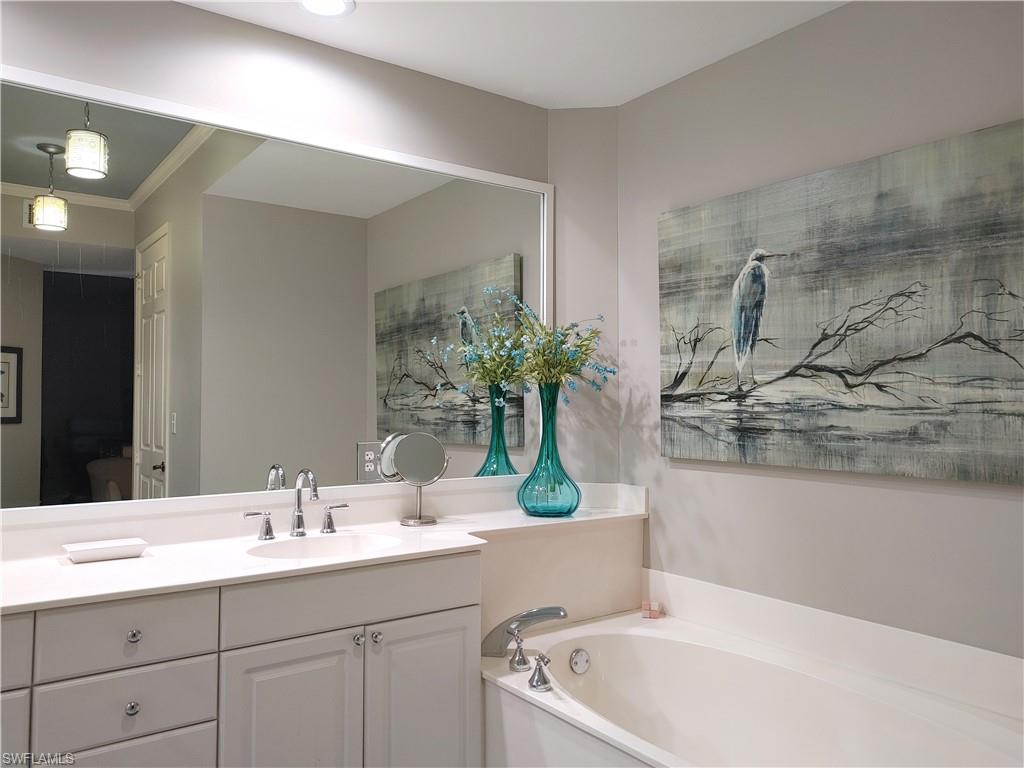 400 Flagship Drive, Unit 501 Naples, FL 34108 - Photo 21 of 38 a white bath tub sitting next to a bathroom sink