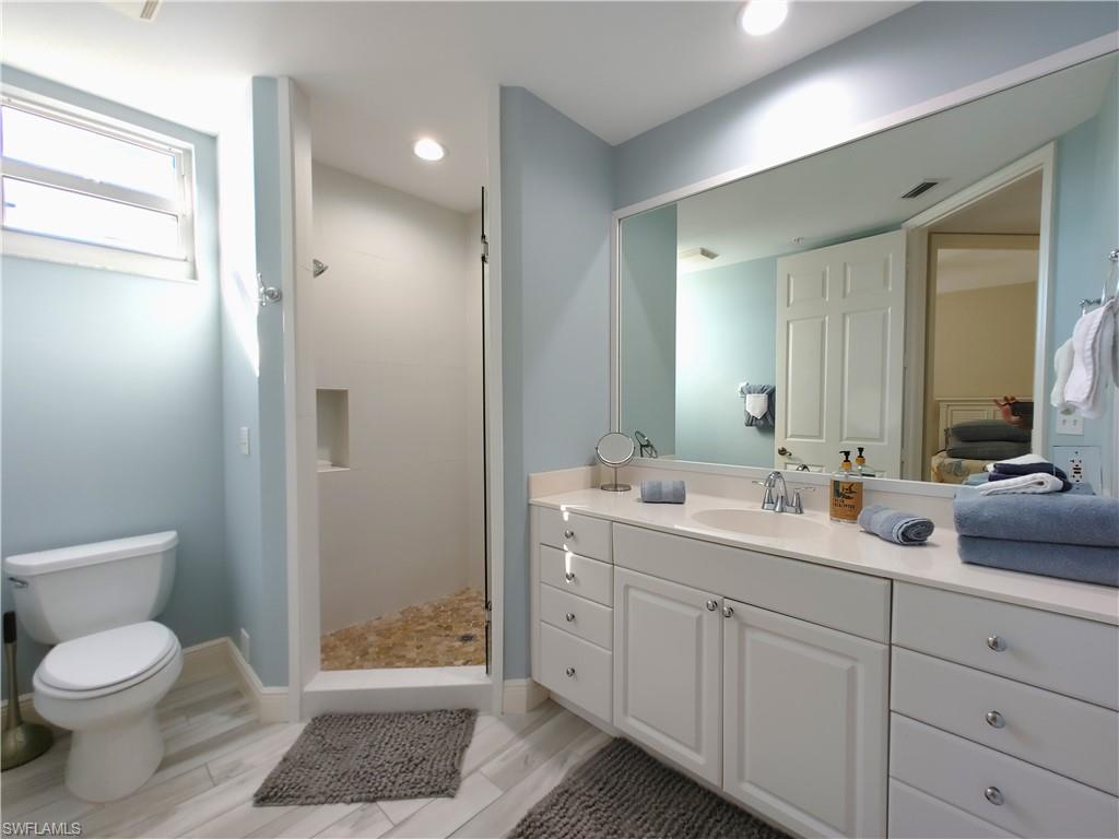 400 Flagship Drive, Unit 501 Naples, FL 34108 - Photo 24 of 38 a bathroom with a toilet a sink and a mirror