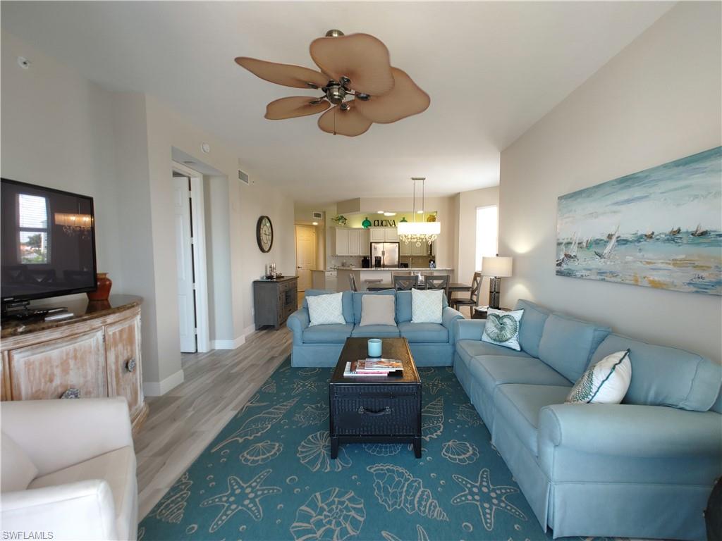 400 Flagship Drive, Unit 501 Naples, FL 34108 - Photo 25 of 38 a living room with furniture and a flat screen tv