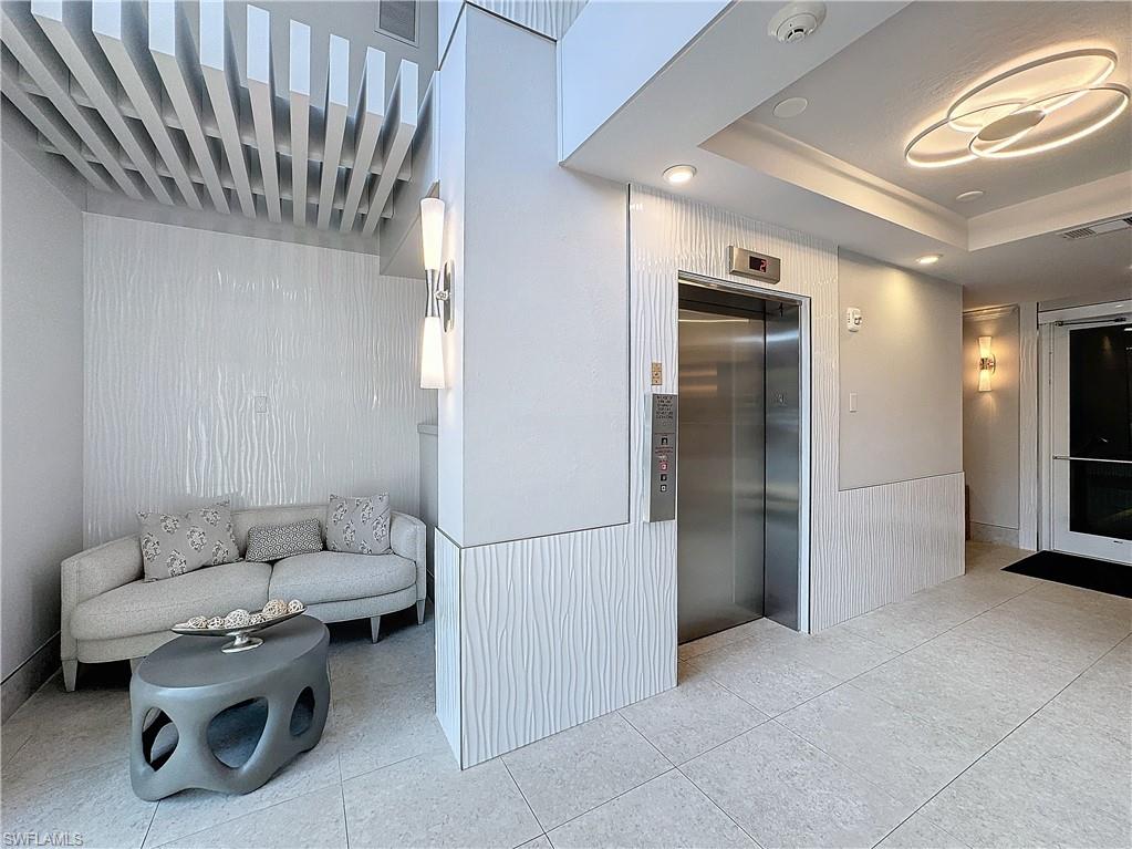 400 Flagship Drive, Unit 501 Naples, FL 34108 - Photo 3 of 38 a living room with furniture and a air conditioner vent