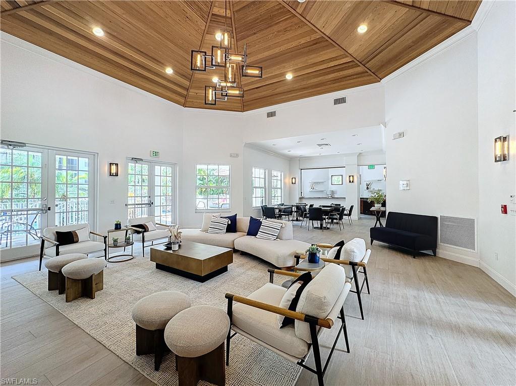 400 Flagship Drive, Unit 501 Naples, FL 34108 - Photo 34 of 38 a living room with furniture and a chandelier