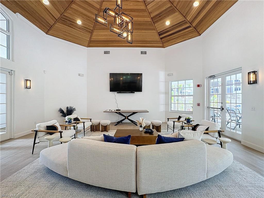 400 Flagship Drive, Unit 501 Naples, FL 34108 - Photo 35 of 38 a living room with furniture and a flat screen tv