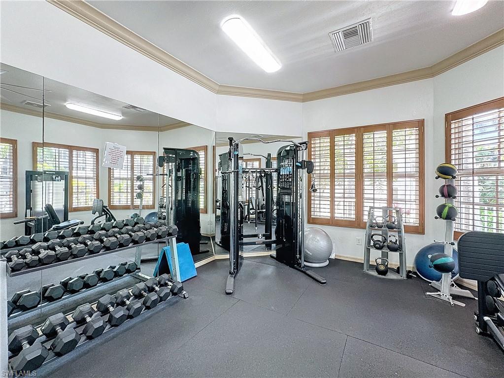 400 Flagship Drive, Unit 501 Naples, FL 34108 - Photo 37 of 38 a bedroom with furniture and large windows