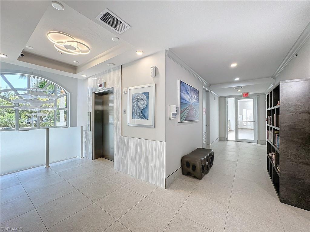 400 Flagship Drive, Unit 501 Naples, FL 34108 - Photo 5 of 38 a living room with furniture a window and stainless steel appliances