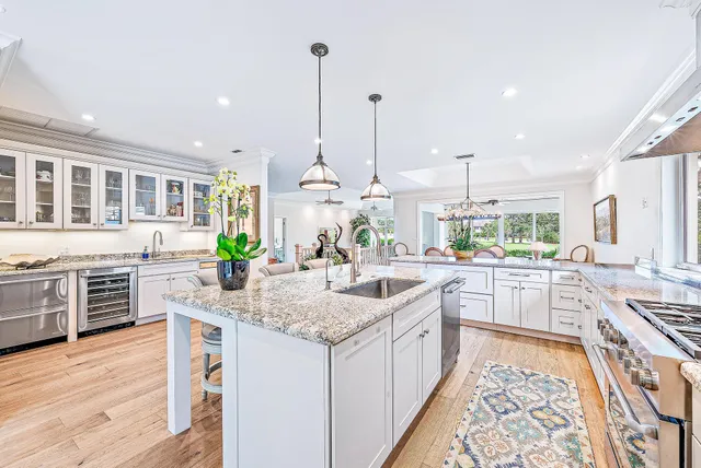 a kitchen with stainless steel appliances granite countertop a sink and cabinets