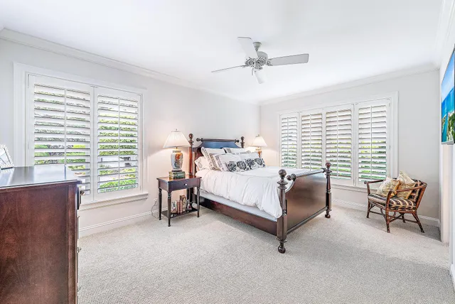 a bedroom with a bed chair and window