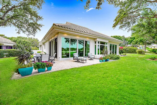 a front view of house with a garden and patio