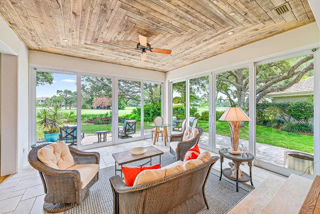 a living room with furniture and garden view