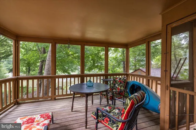 a balcony with wooden floor and outdoor seating