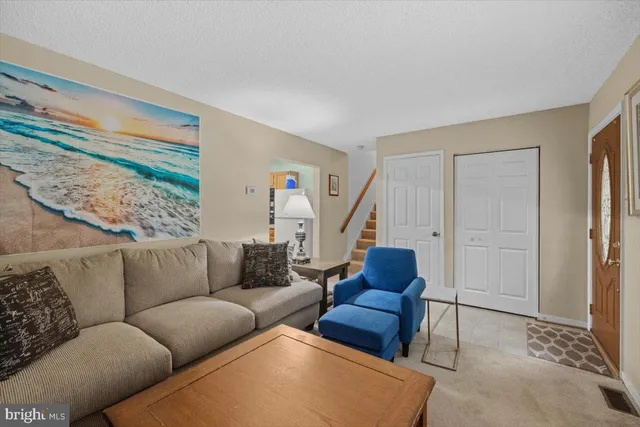 a living room with furniture and a rug