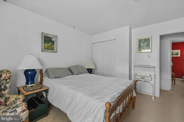 a bedroom with a bed and a table in it