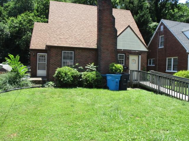 1430 Main Street Southwest Roanoke, VA 24015 - Photo 3 of 21 a front view of a house with a yard and garage