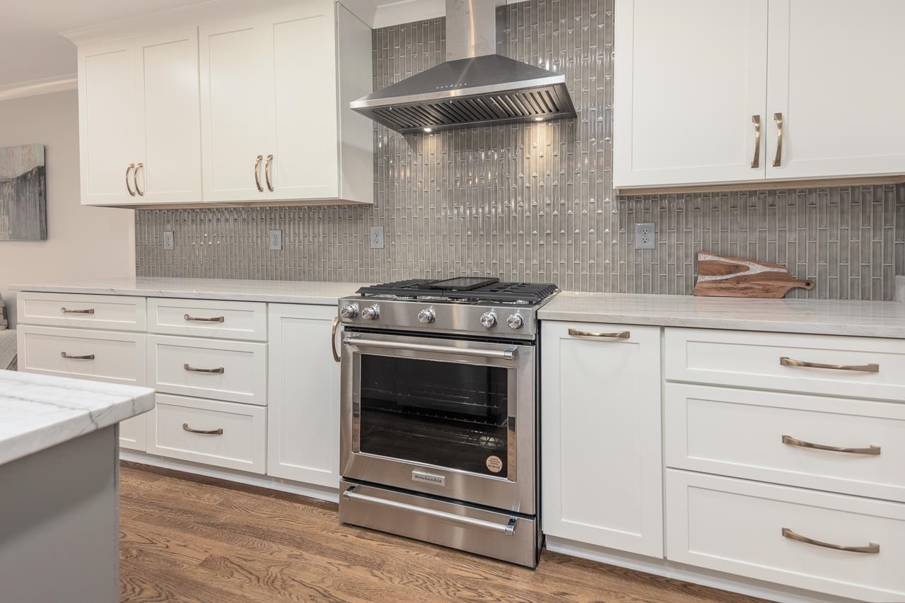 1156 Marcia Road Memphis, TN 38117 - Photo 5 of 40 a kitchen with white cabinets and appliances