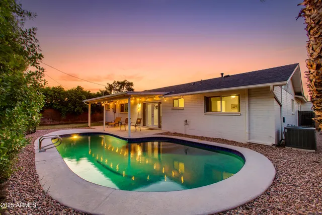 a view of a swimming pool with a patio