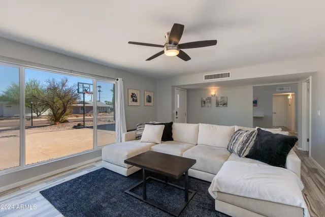a living room with furniture and a large window