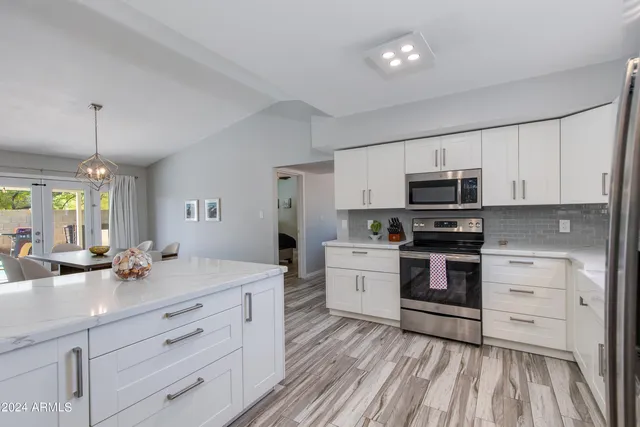 a kitchen with stainless steel appliances a stove microwave and cabinets