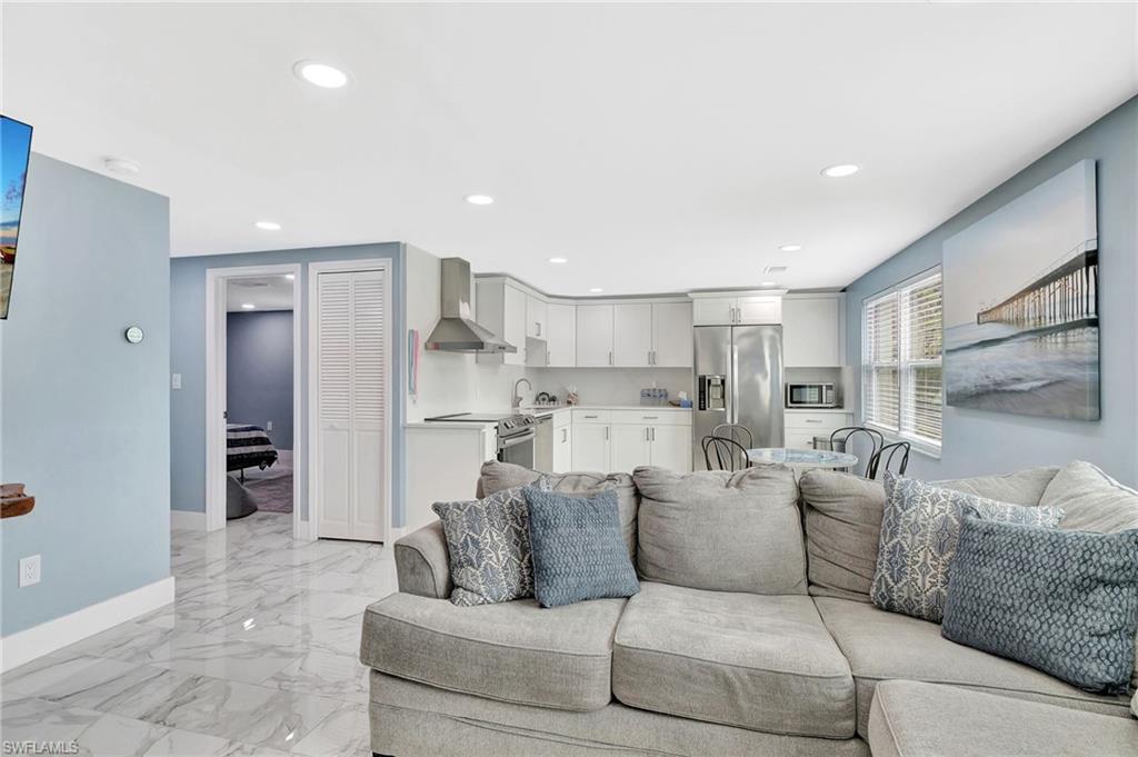 1009 Ridge Street Naples, FL 34103 - Photo 13 of 30 Living area with recessed lighting and light marble finish floors