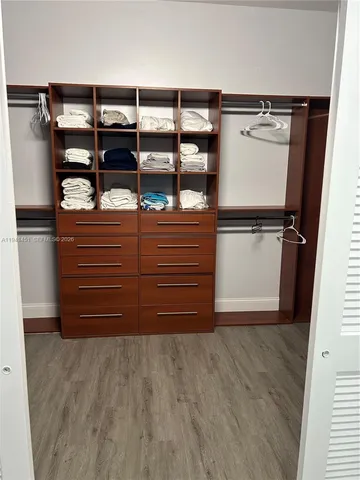 a view of walk in closet with empty racks