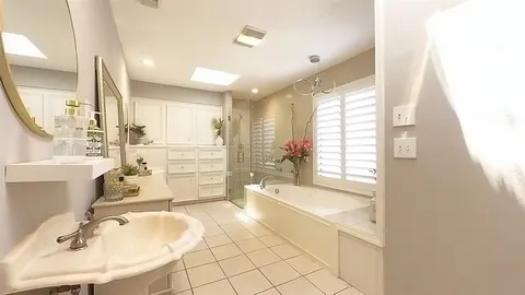 a bathroom with a tub sink and mirror