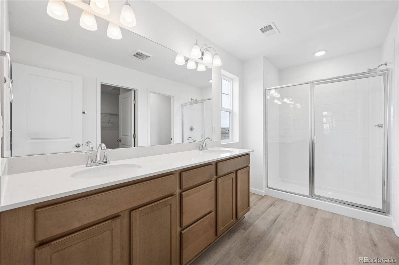 424 South Rifle Street Aurora, CO 80017 - Photo 13 of 23 a bathroom with a double vanity sink mirror and shower