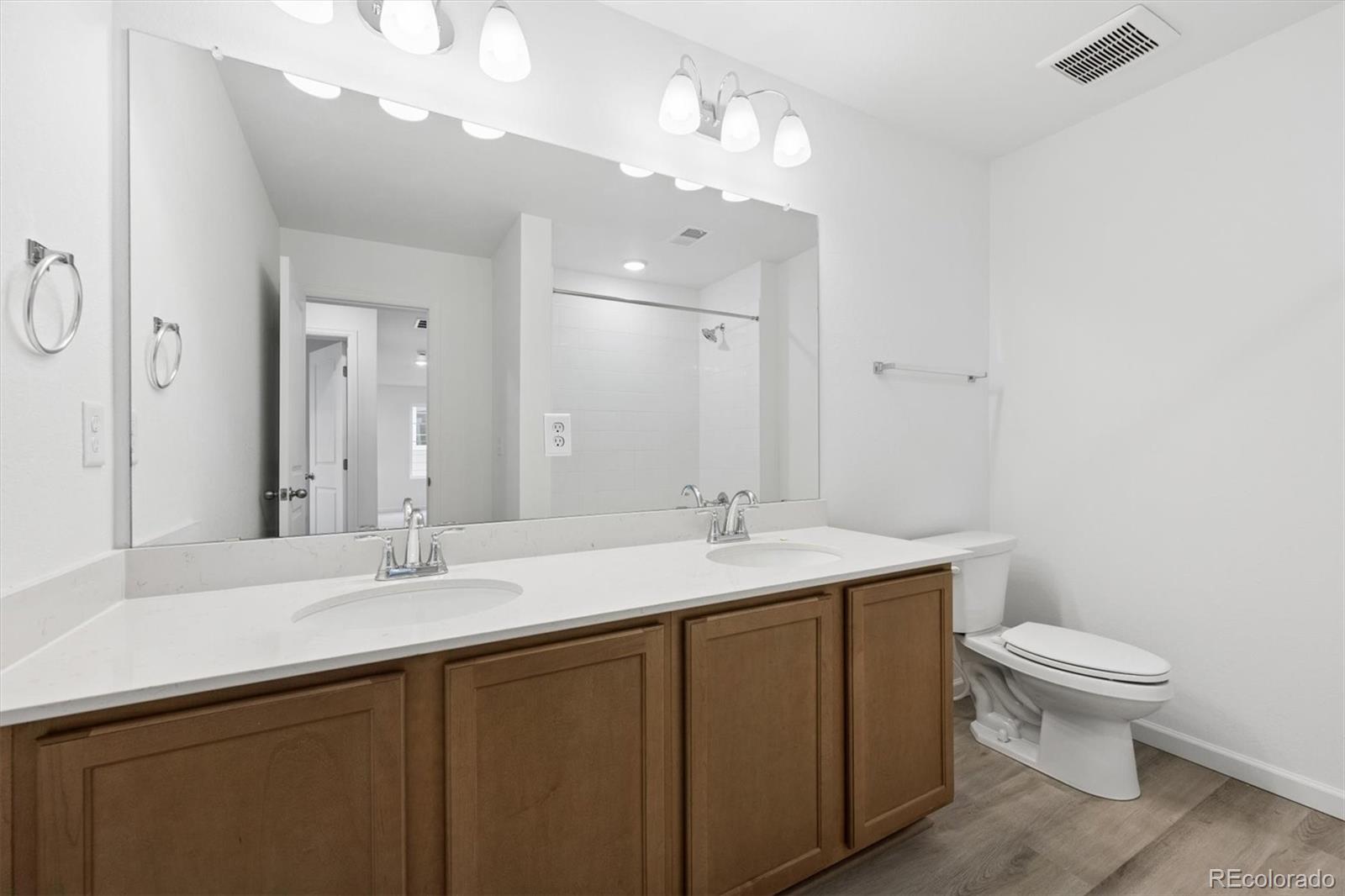 424 South Rifle Street Aurora, CO 80017 - Photo 14 of 23 a bathroom with a sink a toilet and mirror