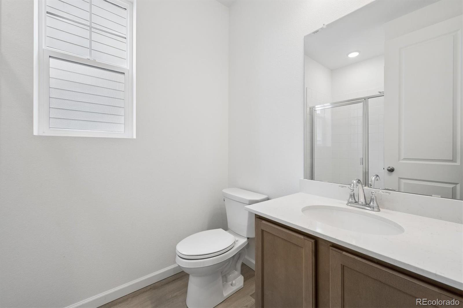 424 South Rifle Street Aurora, CO 80017 - Photo 18 of 23 a bathroom with a sink a toilet and a mirror