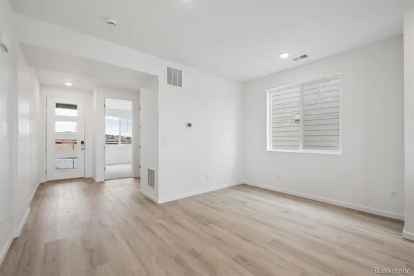 wooden floor in an empty room with a window