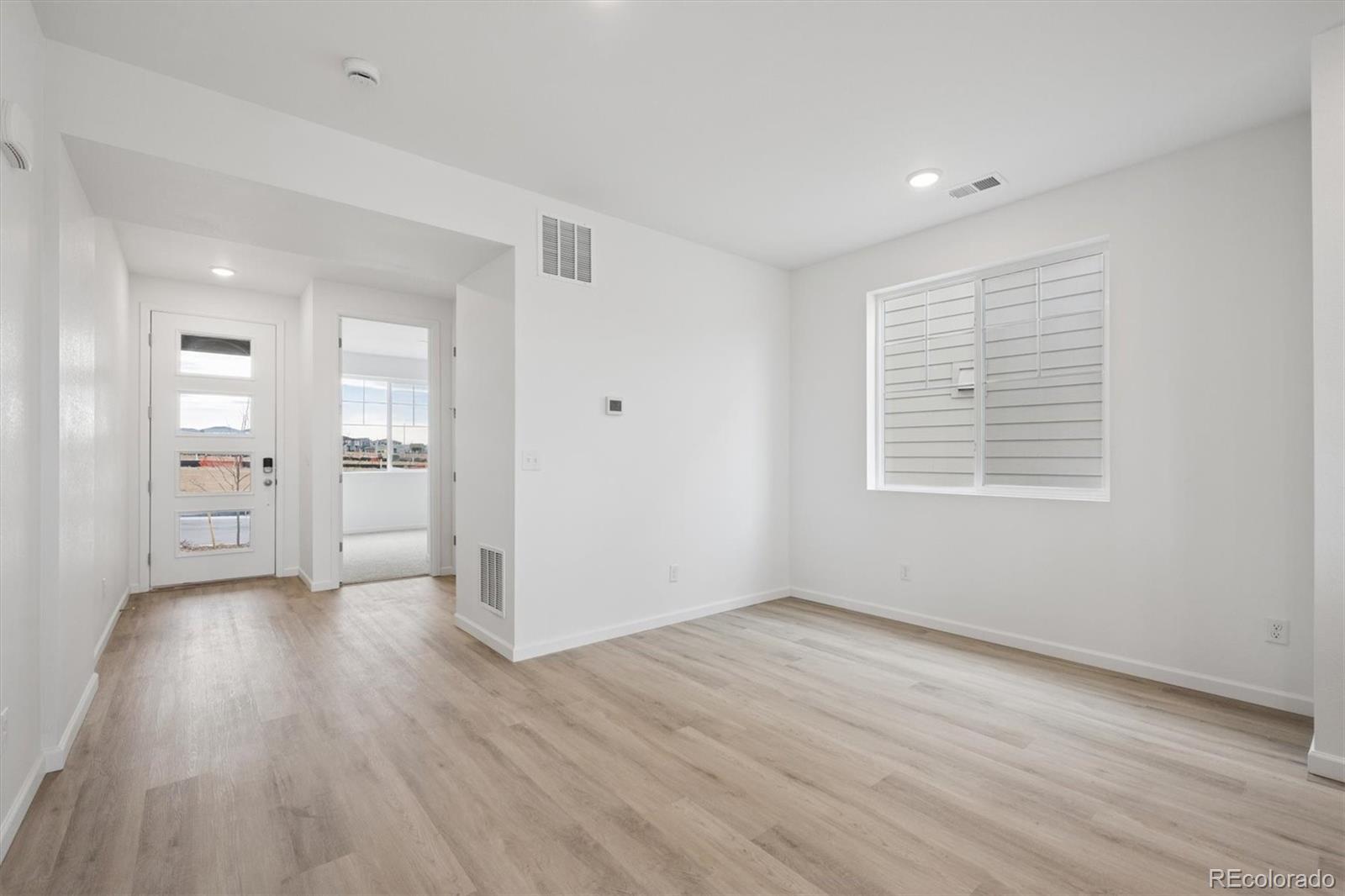 424 South Rifle Street Aurora, CO 80017 - Photo 3 of 23 wooden floor in an empty room with a window