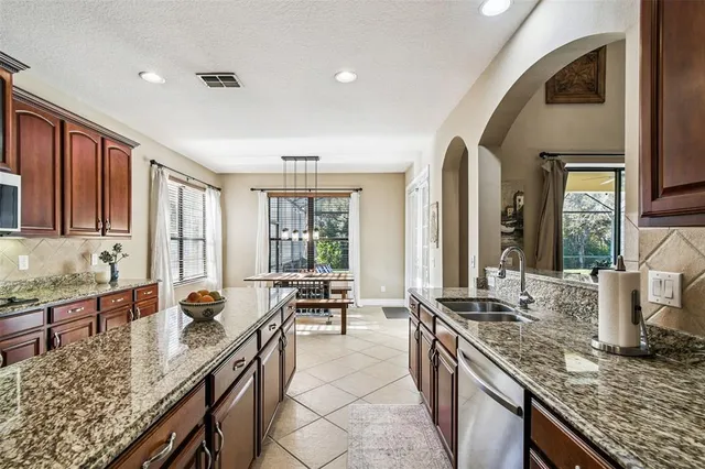 a view of a hallway with a livingroom and windows