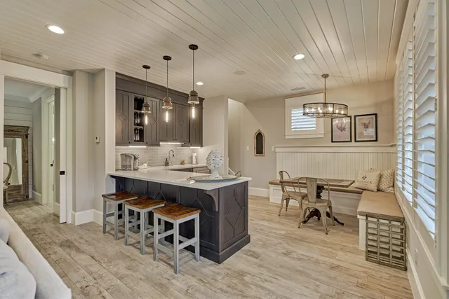 a view of a dining room with furniture and a chandelier