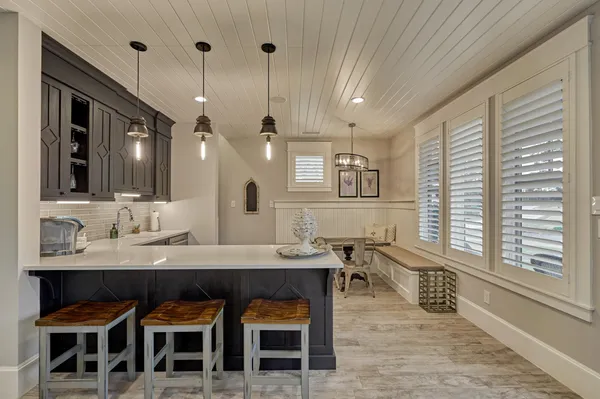 a kitchen with granite countertop a sink a counter top space and stainless steel appliances