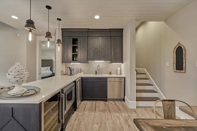 a bedroom with a large bed and a chandelier