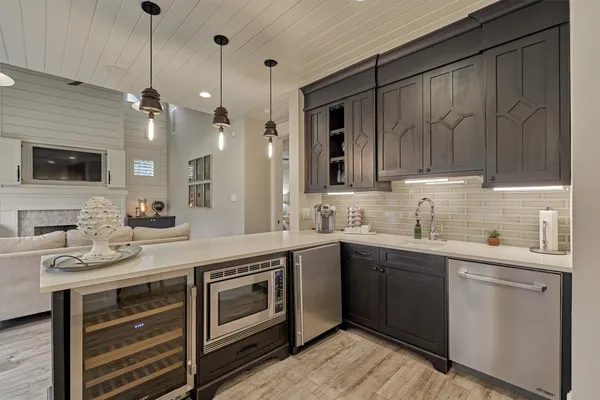 a kitchen with stainless steel appliances granite countertop a sink and cabinets