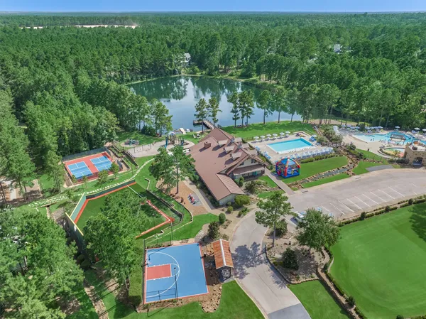 an aerial view of a house with a garden and lake view