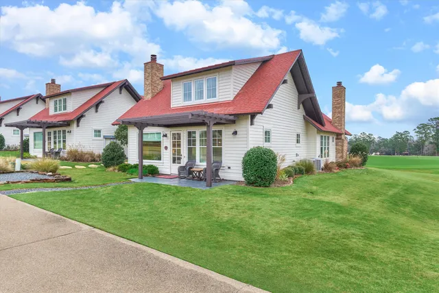 a view of a house with a yard and sitting area