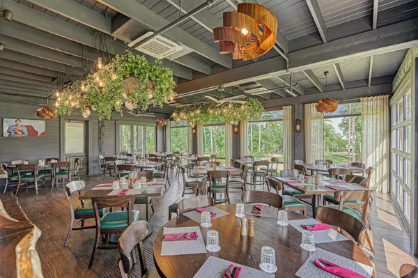 a view of a table & chairs in a garden