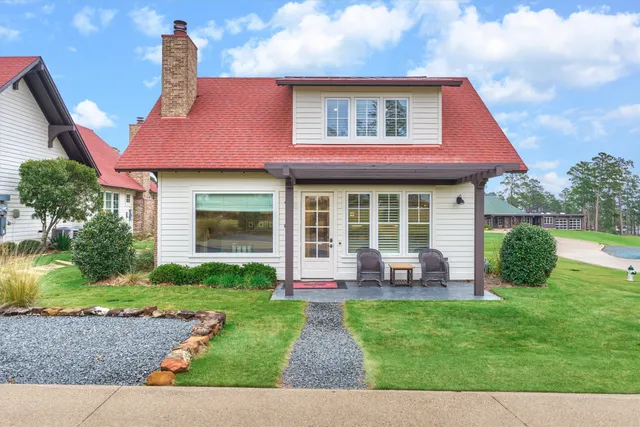 a front view of a house with a yard table and chairs