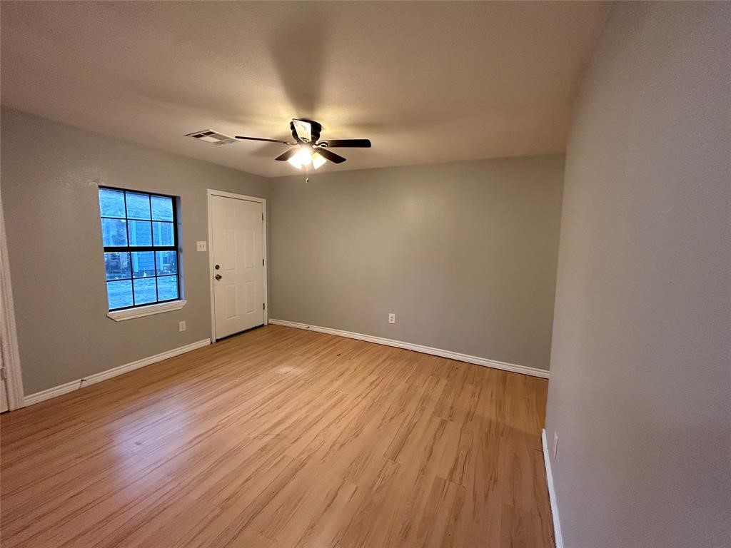 6818 Weston Street, Unit 1 Houston, TX 77021 - Photo 2 of 10 wooden floor in an empty room with a window