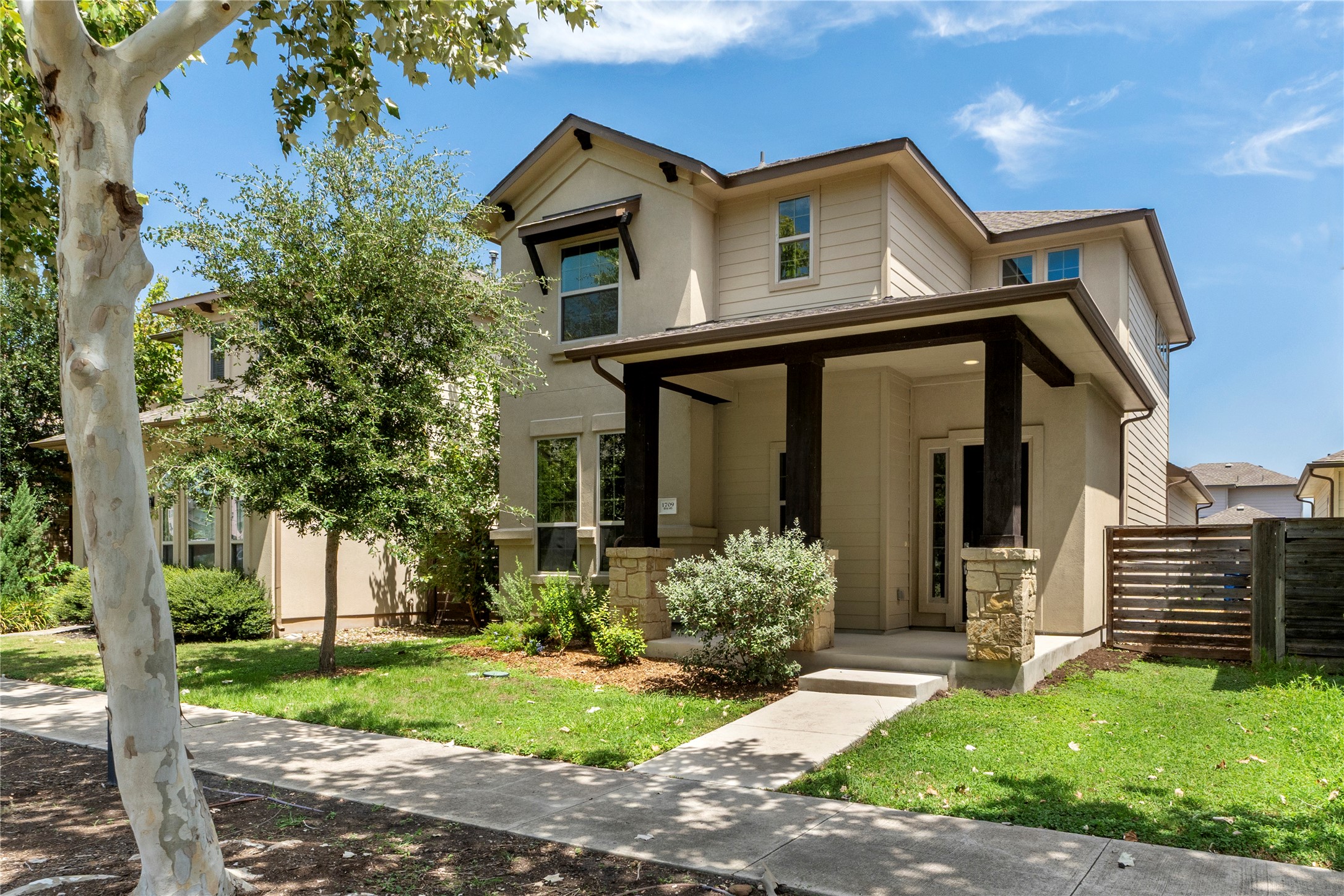 1709 Lawrence Street, Unit 5 Austin, TX 78741 - Photo 2 of 40 A welcoming front porch with stone accents frames the entrance to this two-story home.