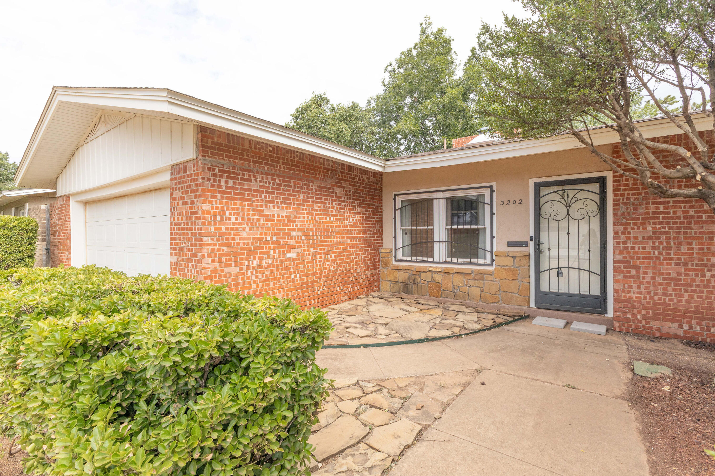 3202 45th Street Lubbock, TX 79413 - Photo 2 of 23 a front view of a house with garden