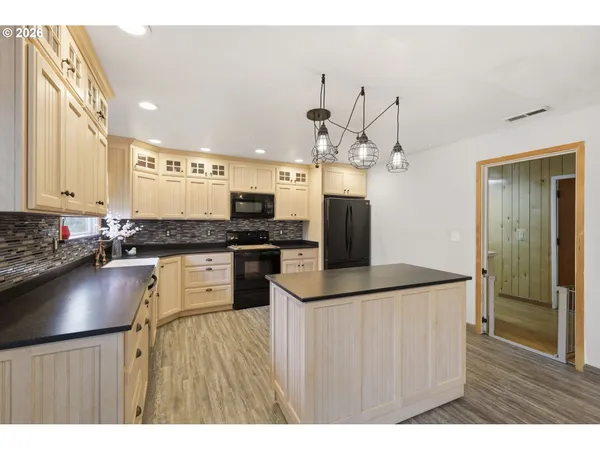a kitchen with granite countertop a sink appliances and cabinets