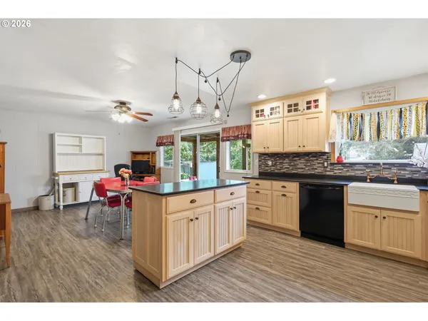 a kitchen with stainless steel appliances granite countertop a stove and cabinets