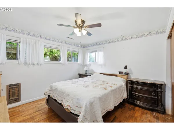 a bedroom with a bed dresser and a window