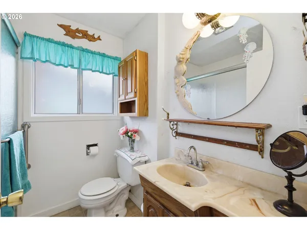 a bathroom with a sink a toilet and a mirror