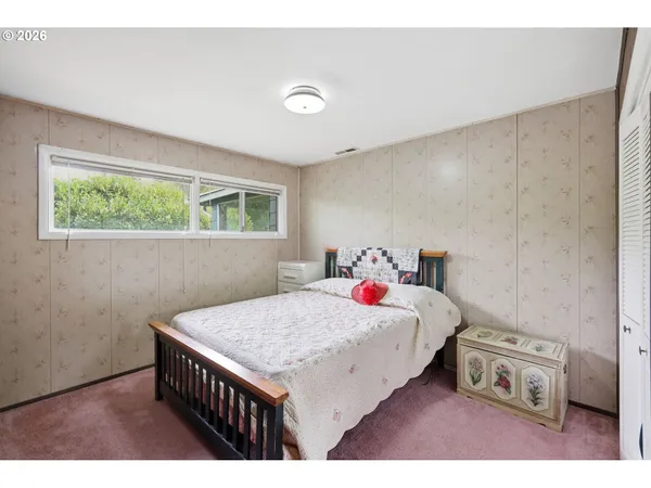 a bedroom with a bed and a table in it