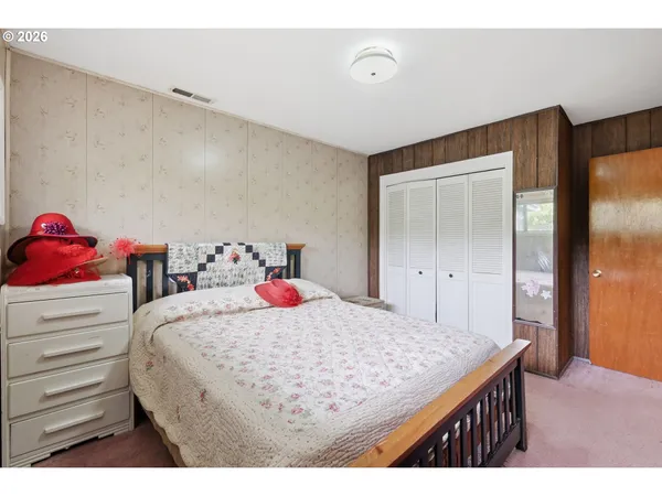 a bedroom with a bed and a dresser