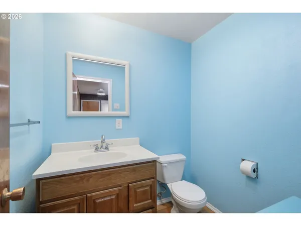 a bathroom with a toilet a sink and mirror
