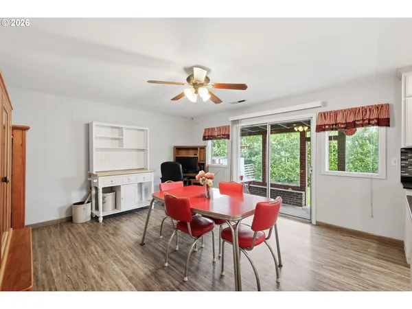 a dining room with furniture a chandelier and wooden floor
