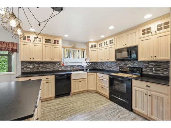 a kitchen with stainless steel appliances granite countertop a stove and cabinets